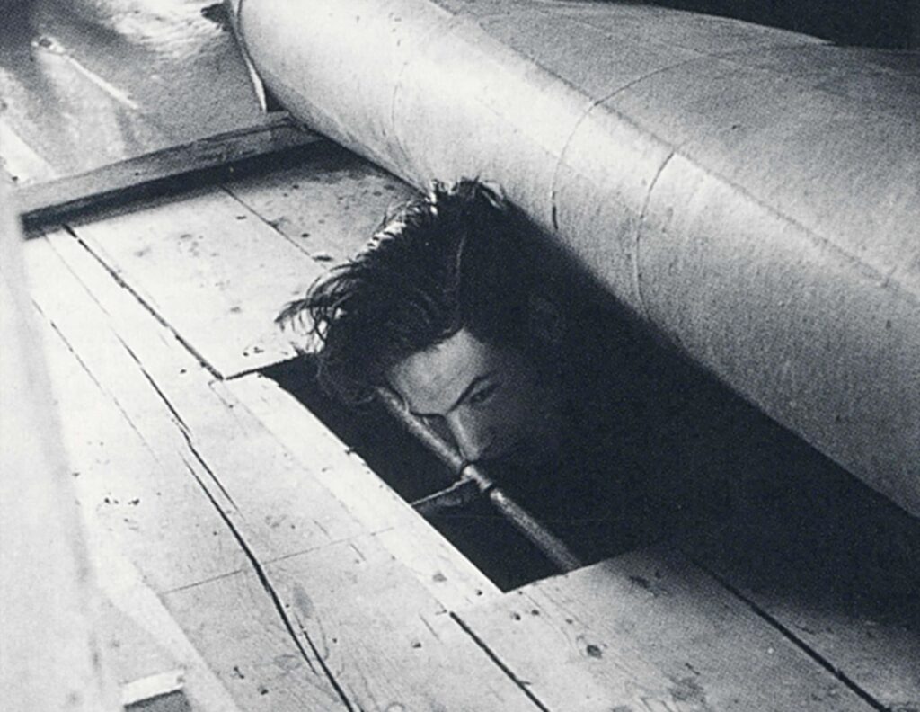 A friend of the photographer hides under the floor in his house. 1944
