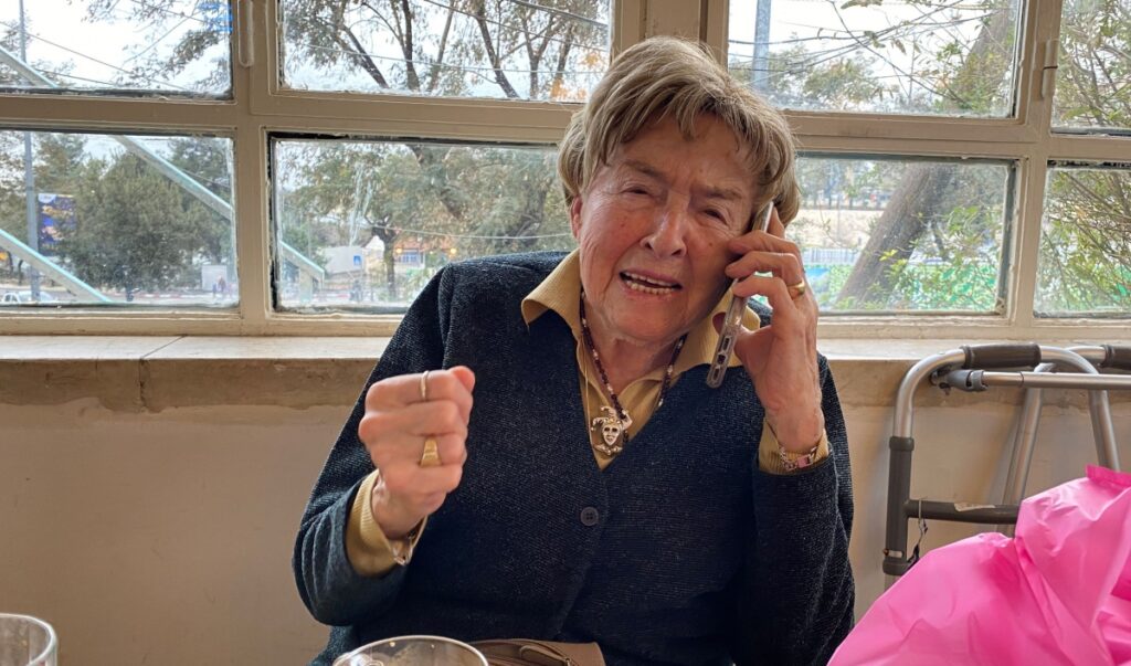 Giselle Cycowicz, a Holocaust survivor living in Jerusalem, shares her story by phone with a group of high school students on the phone as they visit Auschwitz concentration camp. Credit:Courtesy of the Cycowicz family